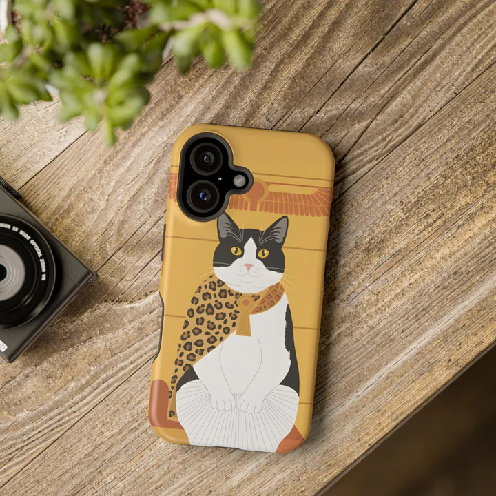 A cat's portrait on a phone case, lying on a table