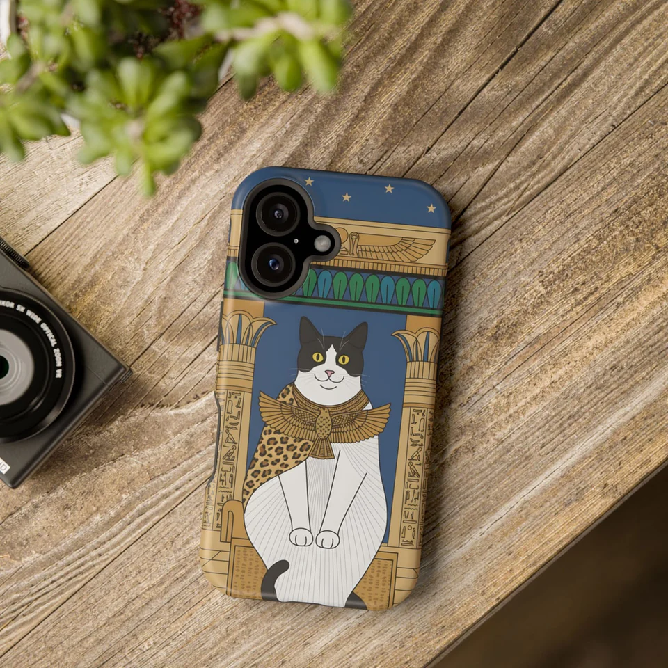 A cat's portrait on a phone case, lying on a table
