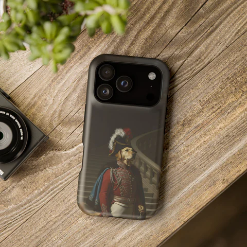 A phone case with a dog as a Napoleonic marshal, on a wooden table.